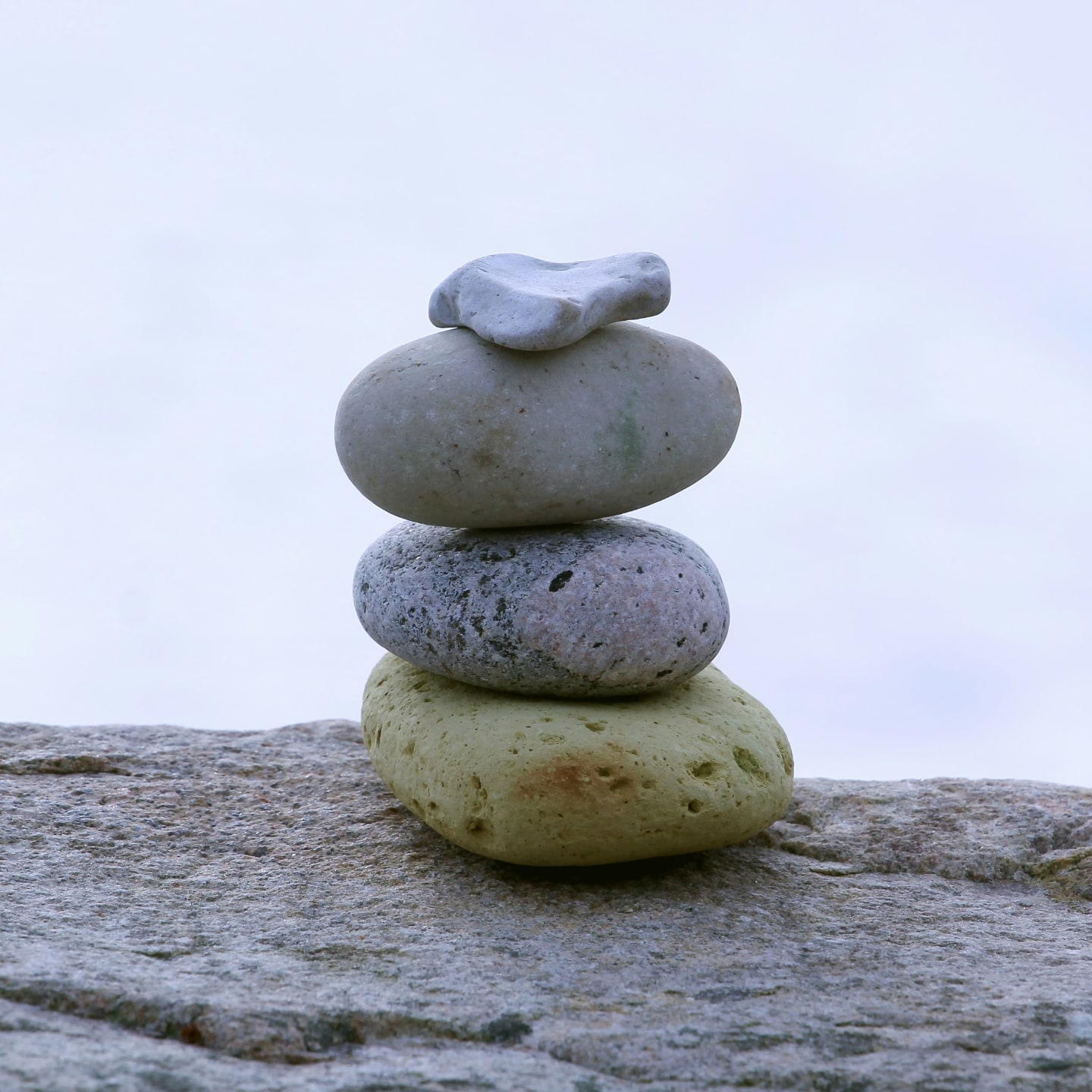 Support after your assessment A stack of rocks sitting on top of a rock.